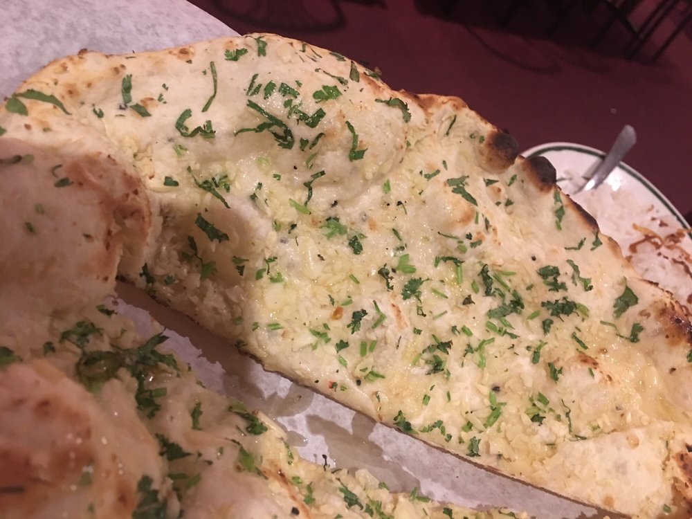 Order Garlic Naan food online from India Garden store, Rochester on bringmethat.com