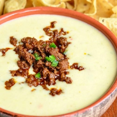 Order Quart of Queso (32oz) food online from Salsarita's Fresh Mexican Grill store, Starkville on bringmethat.com