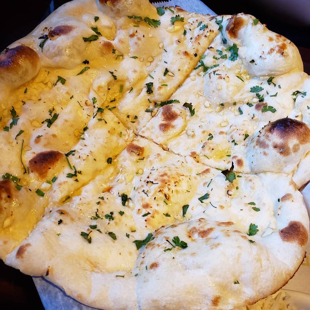 Order Garlic Naan food online from Anmol Restaurant store, Beverly on bringmethat.com