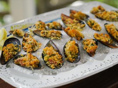 Order Clams Oreganata (12 Pieces) food online from Gino's Trattoria & Pizzeria of New Hyde Park store, New Hyde Park on bringmethat.com